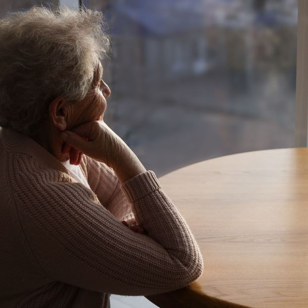 bigstock Elderly Woman Looking Out Of W 452667409