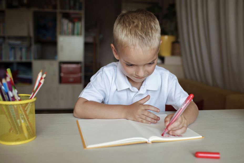 bigstock Happy Left handed Boy Writing  427444814