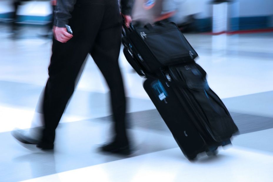 bigstock Man rushing through an airport 26133110