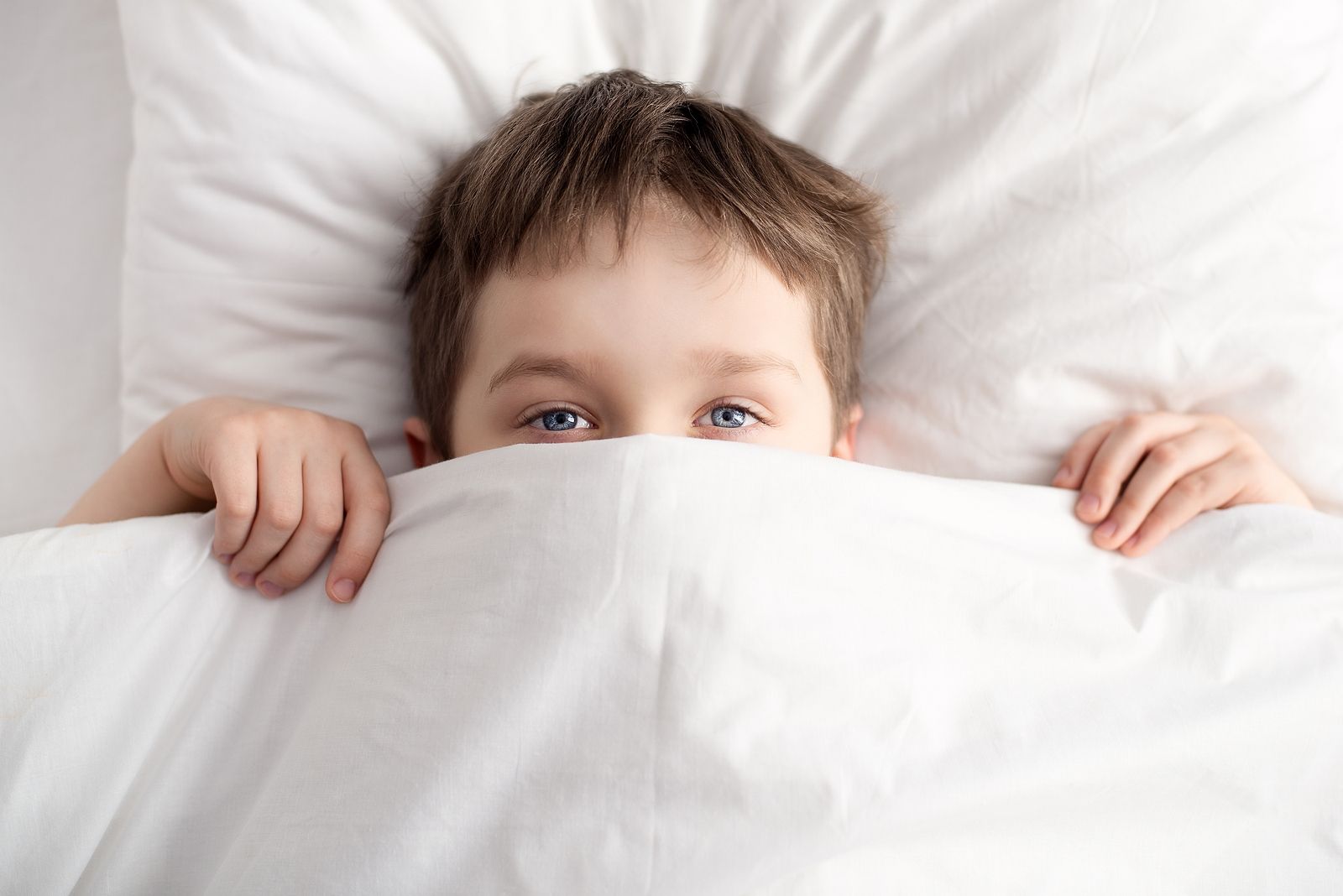 bigstock Little Boy In Bed Covering His 120298484