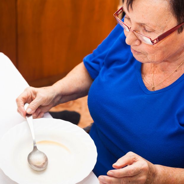 Mujer mayor con el plato vacío. Fuente: Bigstock